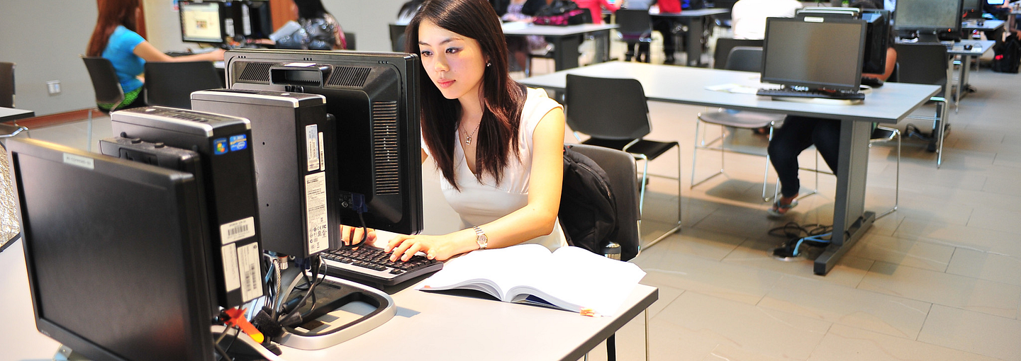 Students on computers in the library